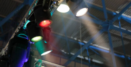 Stage lighting fixtures hanging on a truss. Selective focus.